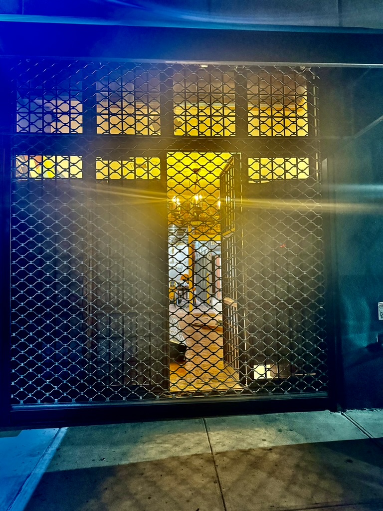 A closer view of the new Fresh Pops gate with the door open and the space lit from inside.