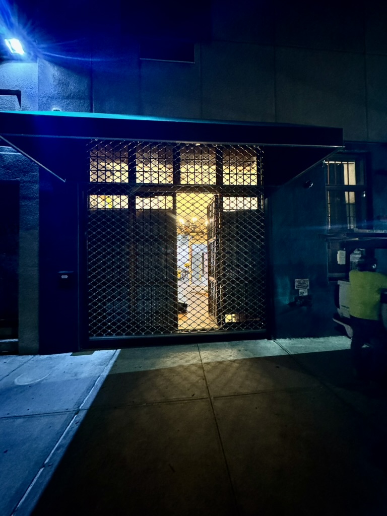 The new Fresh Pops gate installed at night with warm light coming from inside.