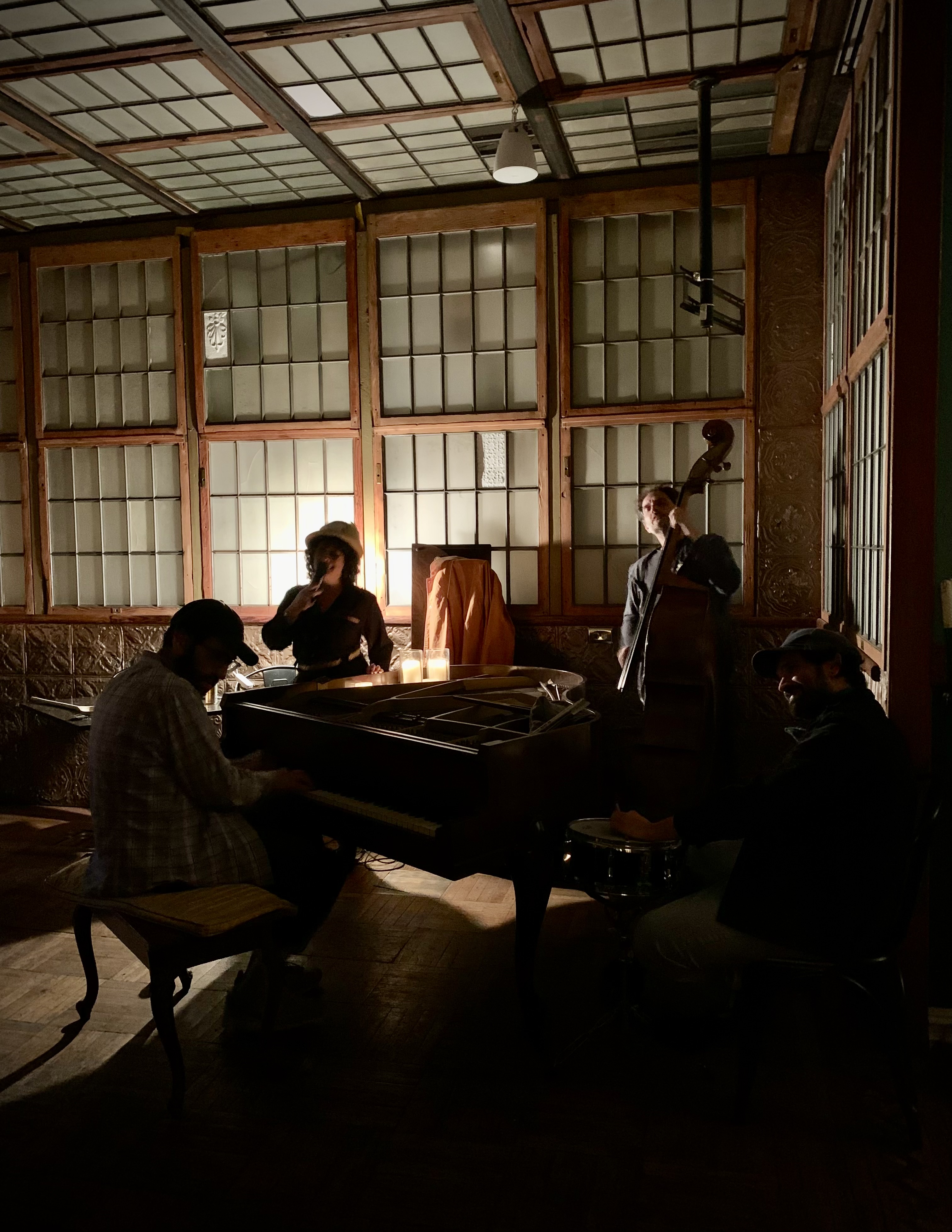 A trio playing in the dim room before construction began.